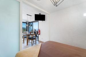 a bedroom with a bed and a dining room with a table at Apartamento El Moral in Frontera
