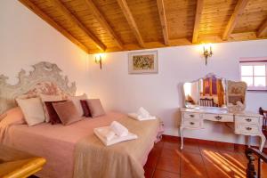 a bedroom with two beds with a mirror and a dresser at Villa Oliva Al ii in Moncarapacho +19 photos