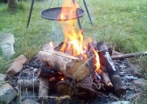 a fire pit with a pot on top of it at Sigmundenhof Schonach in Ölberg