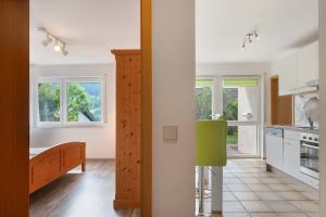 a kitchen with white walls and windows and a staircase at Haus Reiser in Alpirsbach
