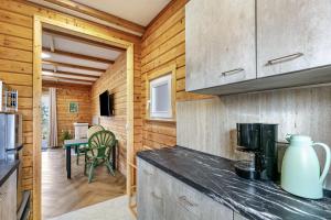 a kitchen with wooden walls and a counter top at Holzhaus am Waldrand in Niederfinow