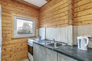 a kitchen with a sink and a window at Holzhaus am Waldrand in Niederfinow +34 photos