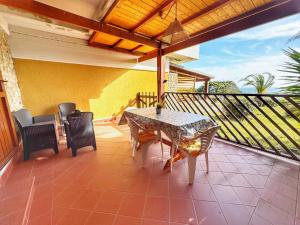a patio with a table and chairs on a balcony at Casa 3 Punta Negra in Stintino +6 photos