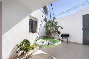 a green bathtub hanging from the side of a building at Casinha Da Aldeia in Cela Velha