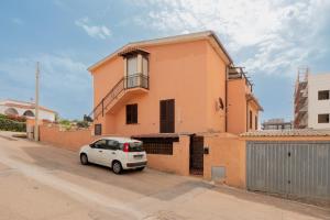 a white car parked in front of a house at Casa Bice 2 in Golfo Aranci +14 photos