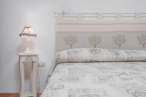a bedroom with a bed and a lamp on a table at Casa Bice 2 in Golfo Aranci