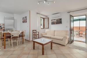 a living room with a couch and a table at Casa Bice 2 in Golfo Aranci