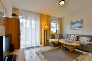 a living room with a couch and a table at Ferienwohnung Tannenblick 3-3 in Oberhof