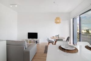 a living room with a couch and a table at Formosa Home in Faro