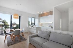 a living room and kitchen with a couch and a table at Formosa Home in Faro