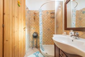 a bathroom with a sink and a shower at Adriana's house in Buggerru +19 photos