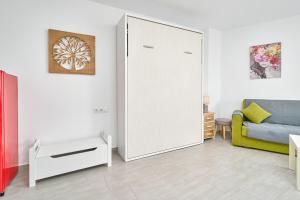 a living room with a large mirror and a couch at Estudio El Faro 2 in Torrox +24 photos
