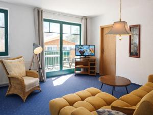a living room with a couch and a table and a tv at Gästehaus Knuth Zinnowitz in Zinnowitz