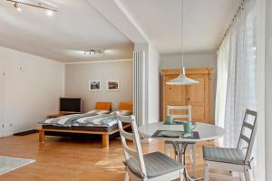 a bedroom with a bed and a table and chairs at Kocher und Jagst in Michelbach an der Bilz