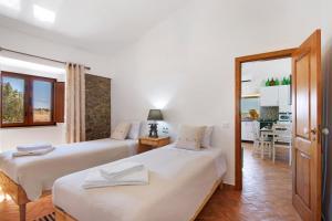 a bedroom with two beds and a dining room at Casas do Monte I in Giões +37 photos