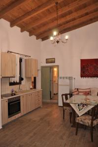 a kitchen with a table and a dining room at House For Rent In Apostolous in Apóstoloi