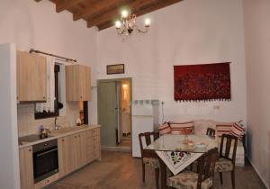 a kitchen with a table and a dining room at House For Rent In Apostolous in Apóstoloi +13 photos