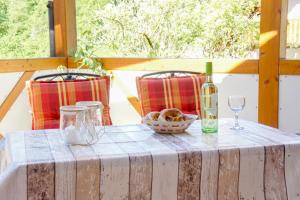 a table with a bottle of wine and a glass at Wellehof in Oberkirch +23 photos