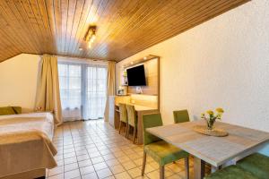 a room with a bed and a table and chairs at Haus Azalea in Olsberg