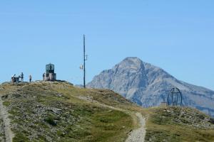 a mountain on top of a hill with a dirt road at Studio Clotes Ski In - Ski Out - Happy Rentals in Sauze dʼOulx