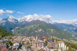 a view of a city with mountains in the background at Studio Clotes Ski In - Ski Out - Happy Rentals in Sauze dʼOulx