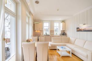 a living room with a couch and a table at Villa Gruner Nr 13 in Zinnowitz