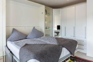 a bedroom with a bed with striped pillows at Ferienwohnung Urs in Schönwald +22 photos