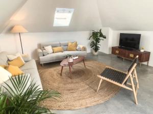 a living room with a couch and a table at Jasmine House in Tavira