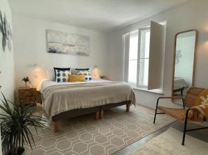 a bedroom with a bed and a large mirror at Jasmine House in Tavira