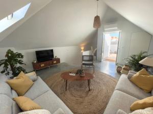 a living room with a couch and a table at Jasmine House in Tavira +12 photos