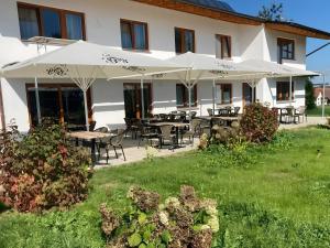 a building with tables and chairs and umbrellas at Casa Rural in Nerenstetten
