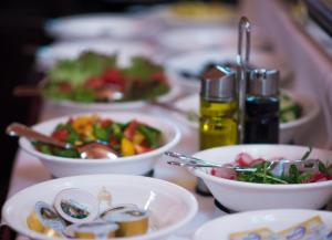 a table topped with bowls of food and vegetables at Hotel König von Ungarn in Vienna
