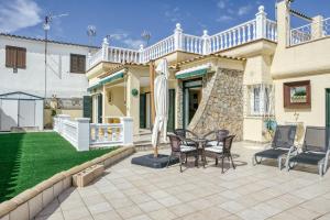 a patio with a table and chairs in front of a house at Villa Empuries A2 in Empuriabrava