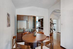a kitchen and dining room with a wooden table and chairs at Casa Leah in Imperia