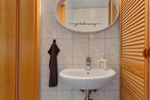 a bathroom with a sink and a mirror at Im Grünen in Weil der Stadt +14 photos