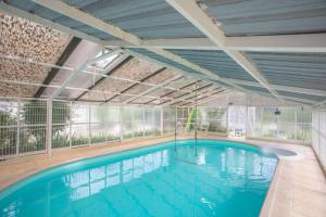 a large swimming pool in a building at Villa la Myreclose in Saint-Auban