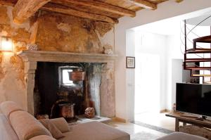 a living room with a couch and a fireplace at Thari House Como Lake in Naggio