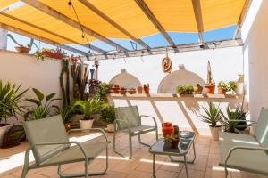 a patio with chairs and potted plants at Civico4 luxuryholidays in Casarano