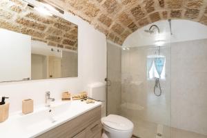 a bathroom with a shower and a toilet and a sink at Civico4 luxuryholidays in Casarano +21 photos
