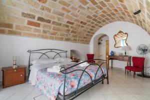 a bedroom with a bed and a brick wall at Civico4 luxuryholidays in Casarano
