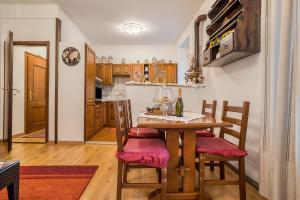 a kitchen and dining room with a table and chairs at Appartamento Collini in Spiazzo