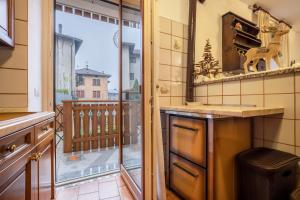 a kitchen with a view of a balcony at Appartamento Collini in Spiazzo +20 photos
