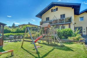 a playground in the yard of a house at Ferienwohnung Seenähe in Mattsee