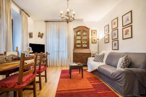 a living room with a couch and a dining room at Appartamento Collini in Spiazzo