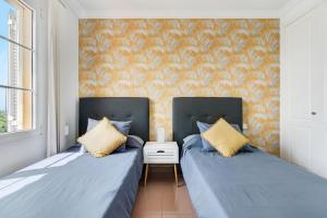 two beds sitting next to each other in a room at Santa Ana 23 in Playa del Ingles +21 photos