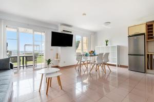 a kitchen and living room with a table and chairs at Santa Ana 23 in Playa del Ingles