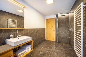 a bathroom with a sink and a shower at App Hubertus - Moosstock in Sand in Taufers +20 photos