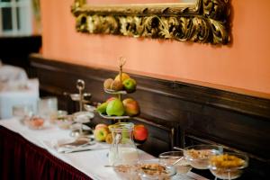 a table with plates of food and fruit on it at Hotel König von Ungarn in Vienna