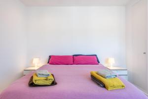 a bedroom with a large bed with pink and yellow blankets at The Olives in Port de Soller