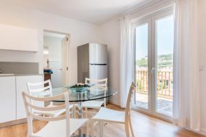 a kitchen and dining room with a glass table and chairs at The Olives in Port de Soller
